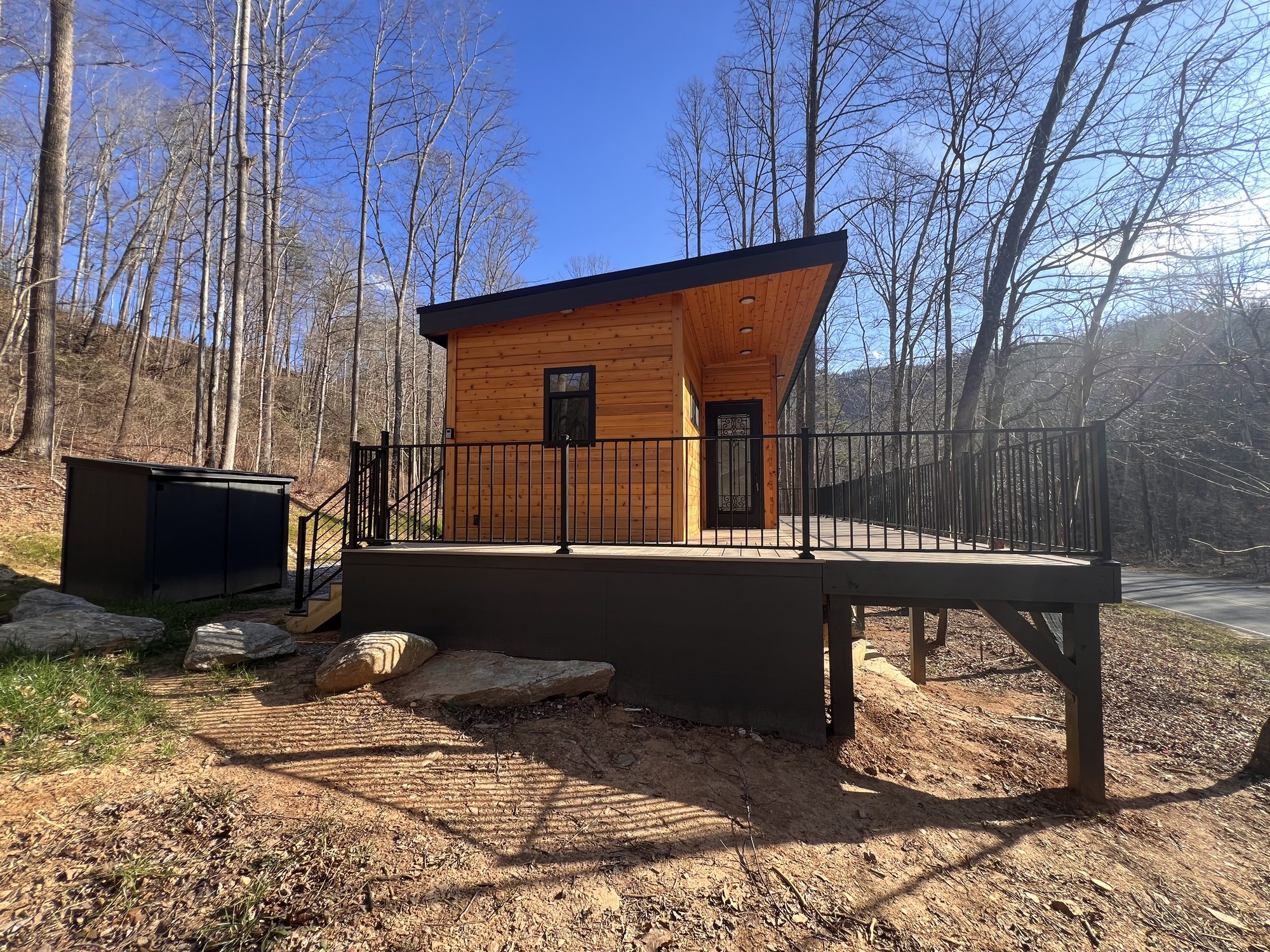 A Sweet-Haus cabin and deck at Trout Stream Cabins under a blue mountain sky